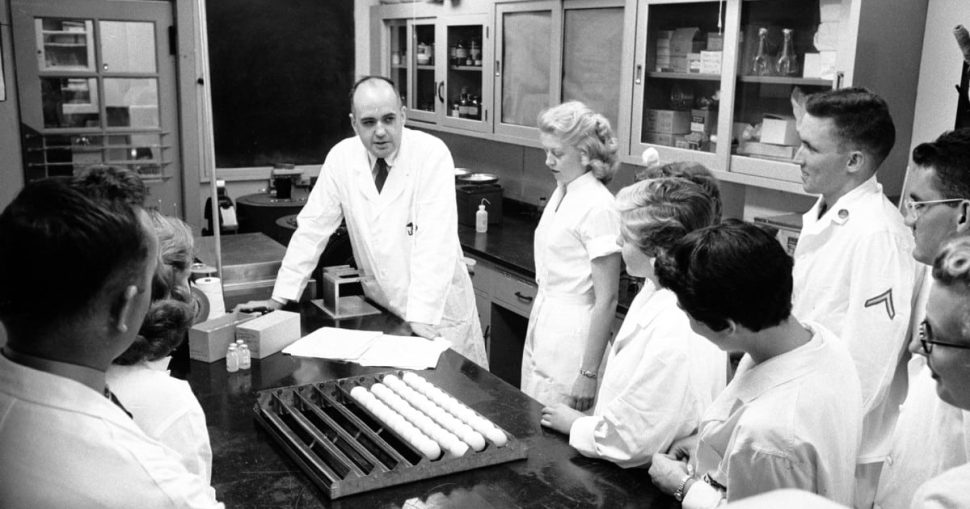 موريس هيلمان متوسطًا فريقه البحثي الذي كان يعمل على علاج للأنفلونزا الآسيوية